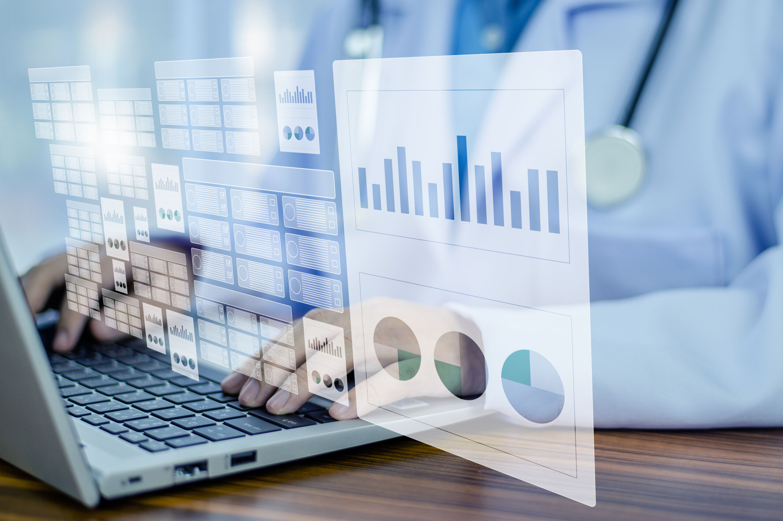 Healthcare supply chain employee utilizing a laptop that displays information via analytics